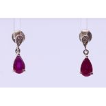 A pair of contemporary ruby and silver earrings with butterfly clips, stamped 925. 1.5 cm high.