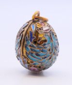 A silver enamel pendant in the form of an egg bearing Russian marks. 2.5 cm high.