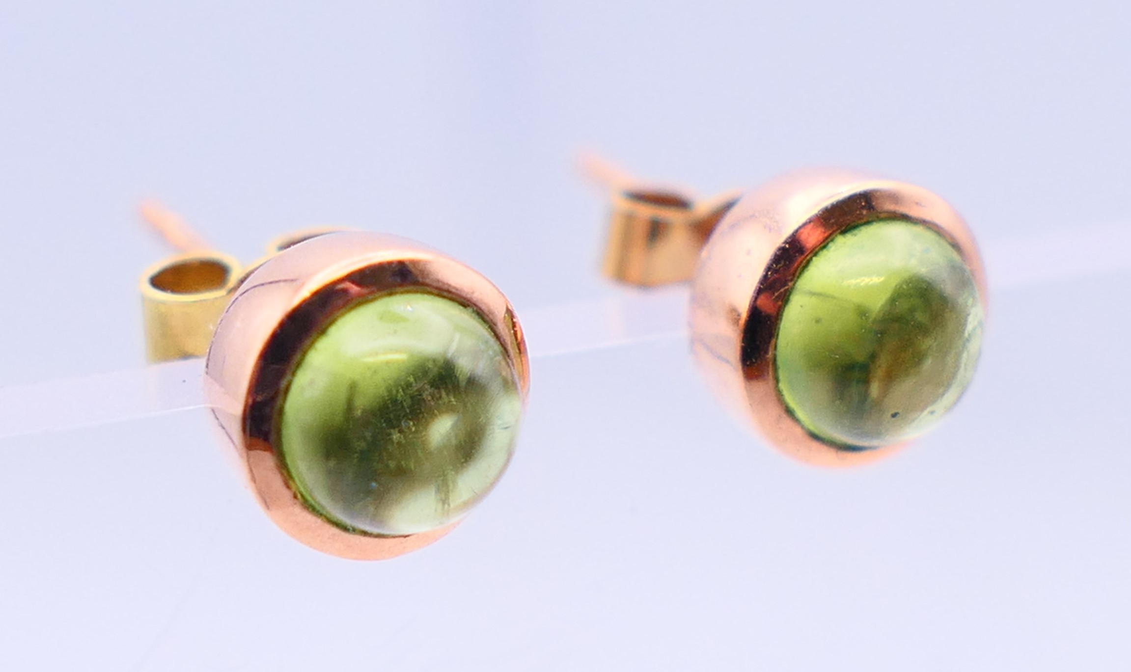A pair of 9 ct rose gold earrings, each set with star cut/cabochon peridot gemstone. 0. - Image 2 of 5