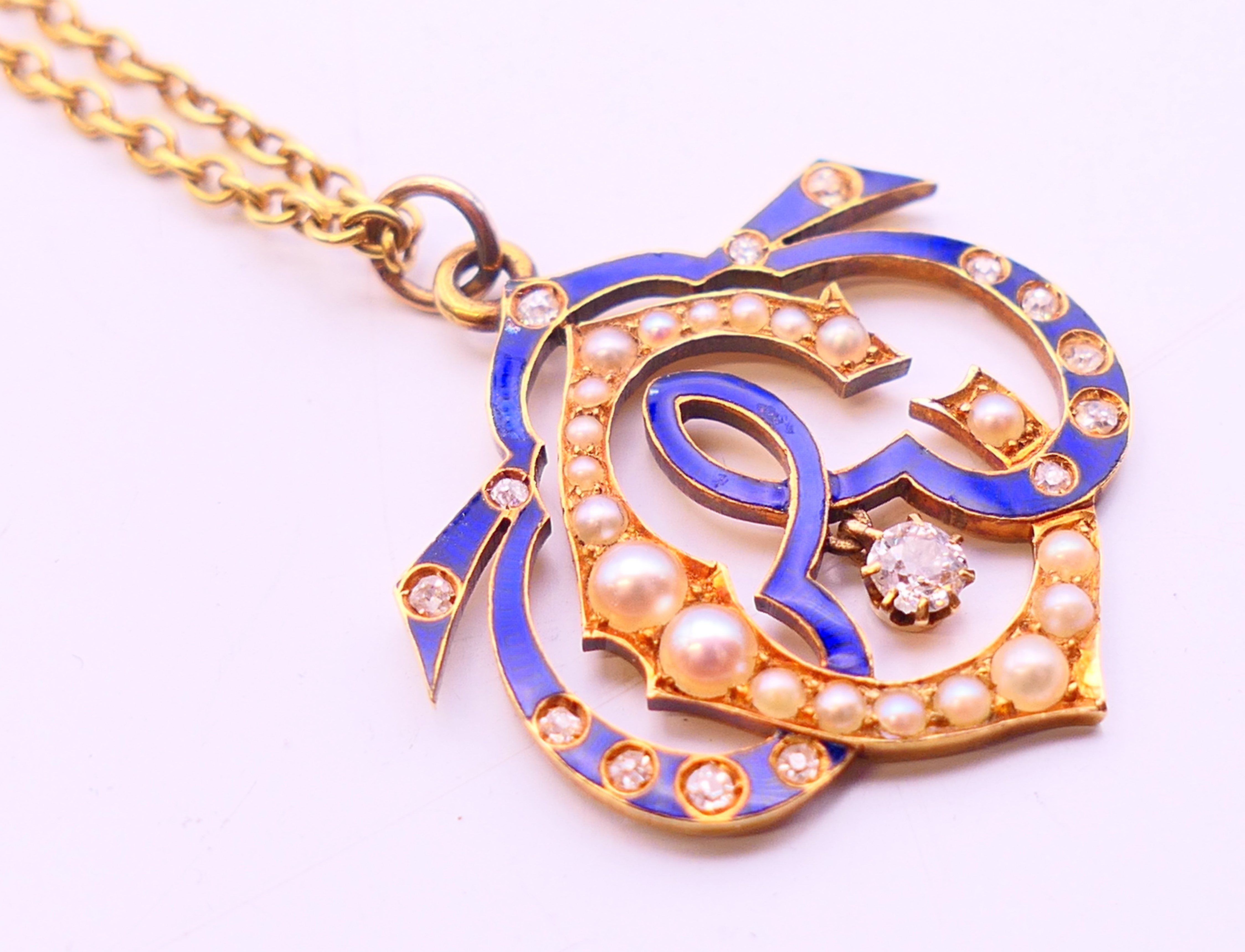 An unmarked, diamond, enamel and seed pearl set pendant on a 9 ct gold chain. Pendant 2. - Image 3 of 5