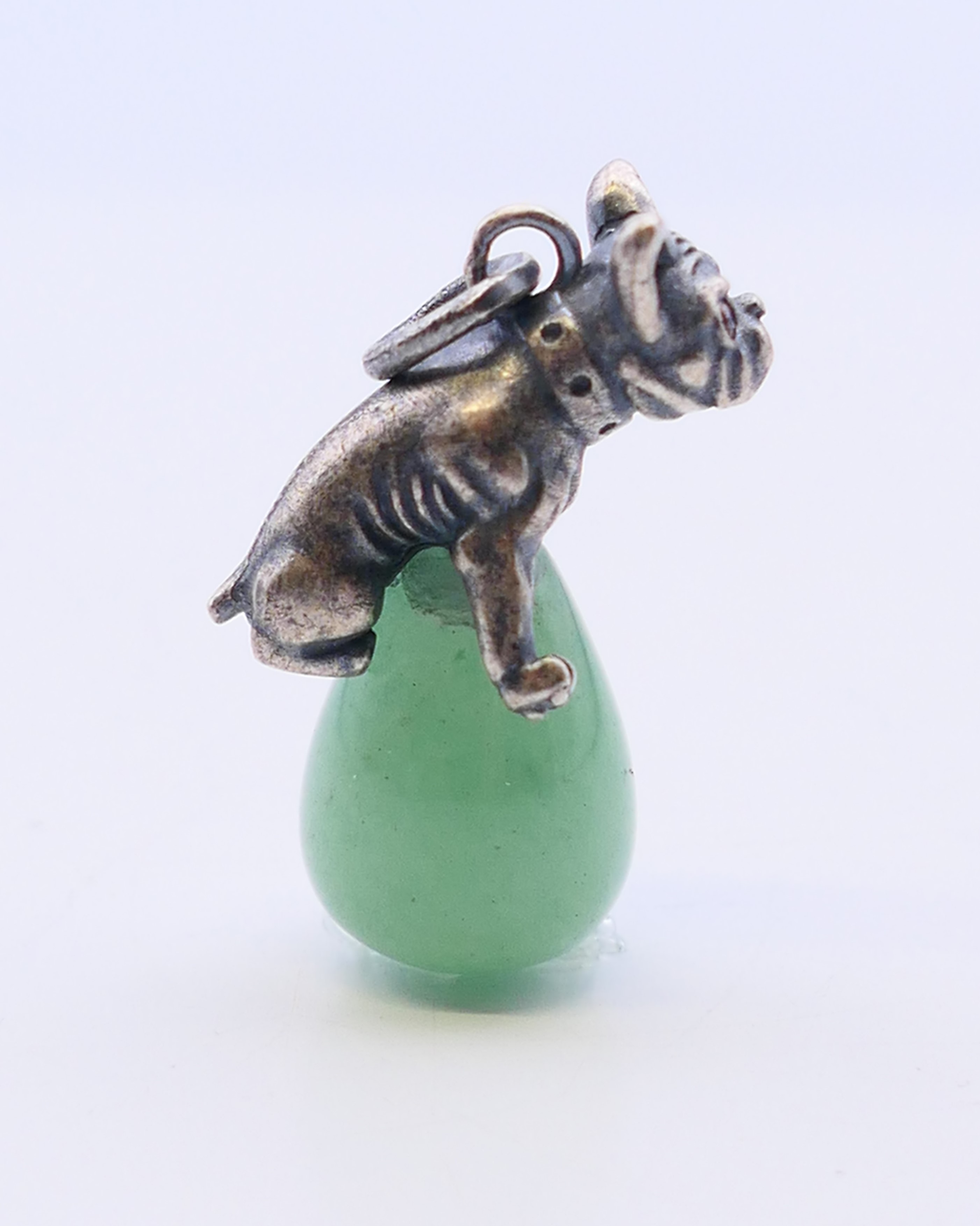 A jade pendant in the form of a dog astride an egg, bearing Russian marks. 3 cm high. - Image 3 of 4