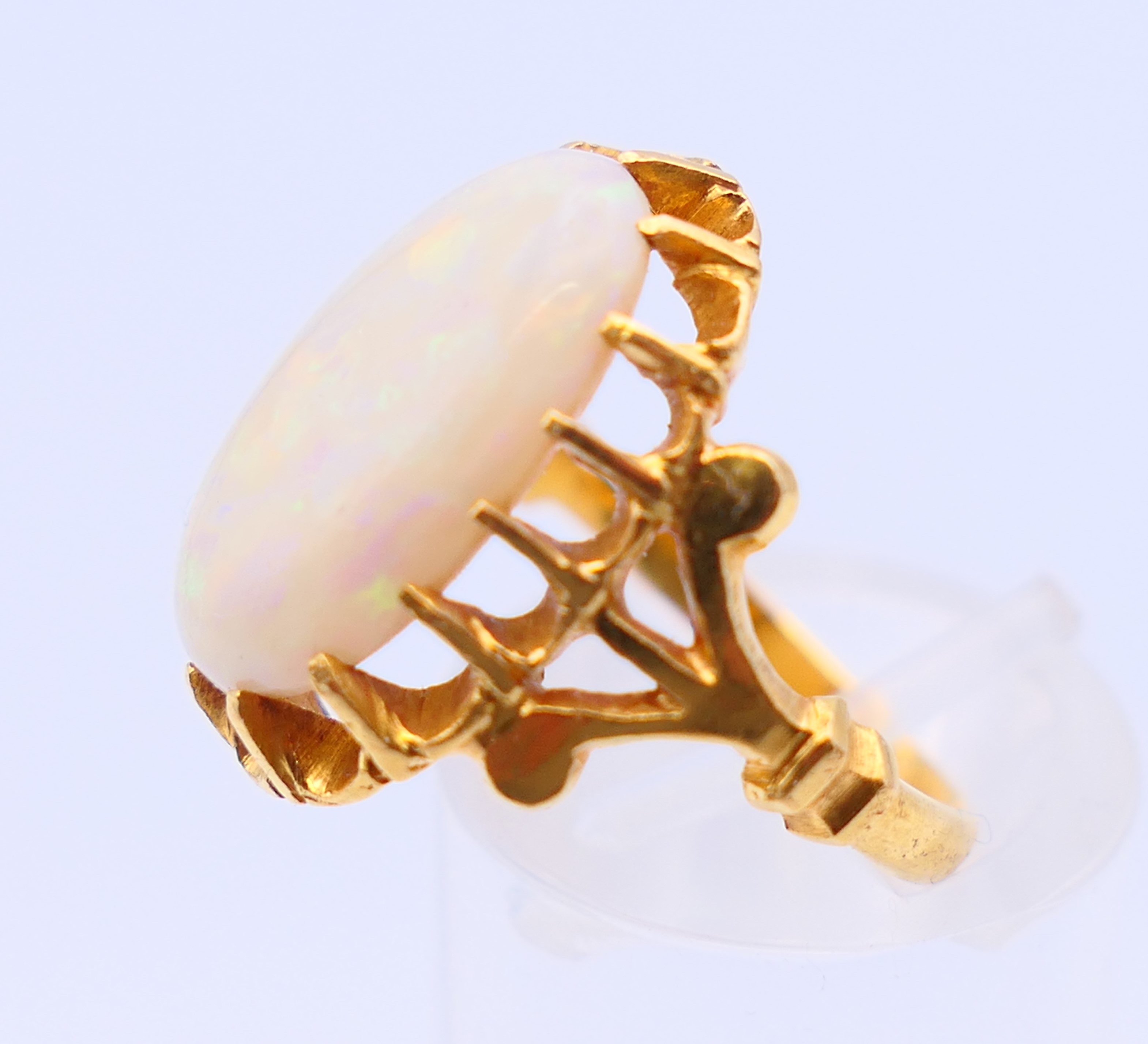 An unmarked 22 ct gold and opal ring. Ring size J. - Image 3 of 5