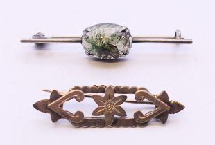 An antique silver brooch and a silver brooch set with a stone. Stone brooch 4.5 cm long.
