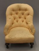 A peach upholstered button back nursing chair. 59 cm wide.