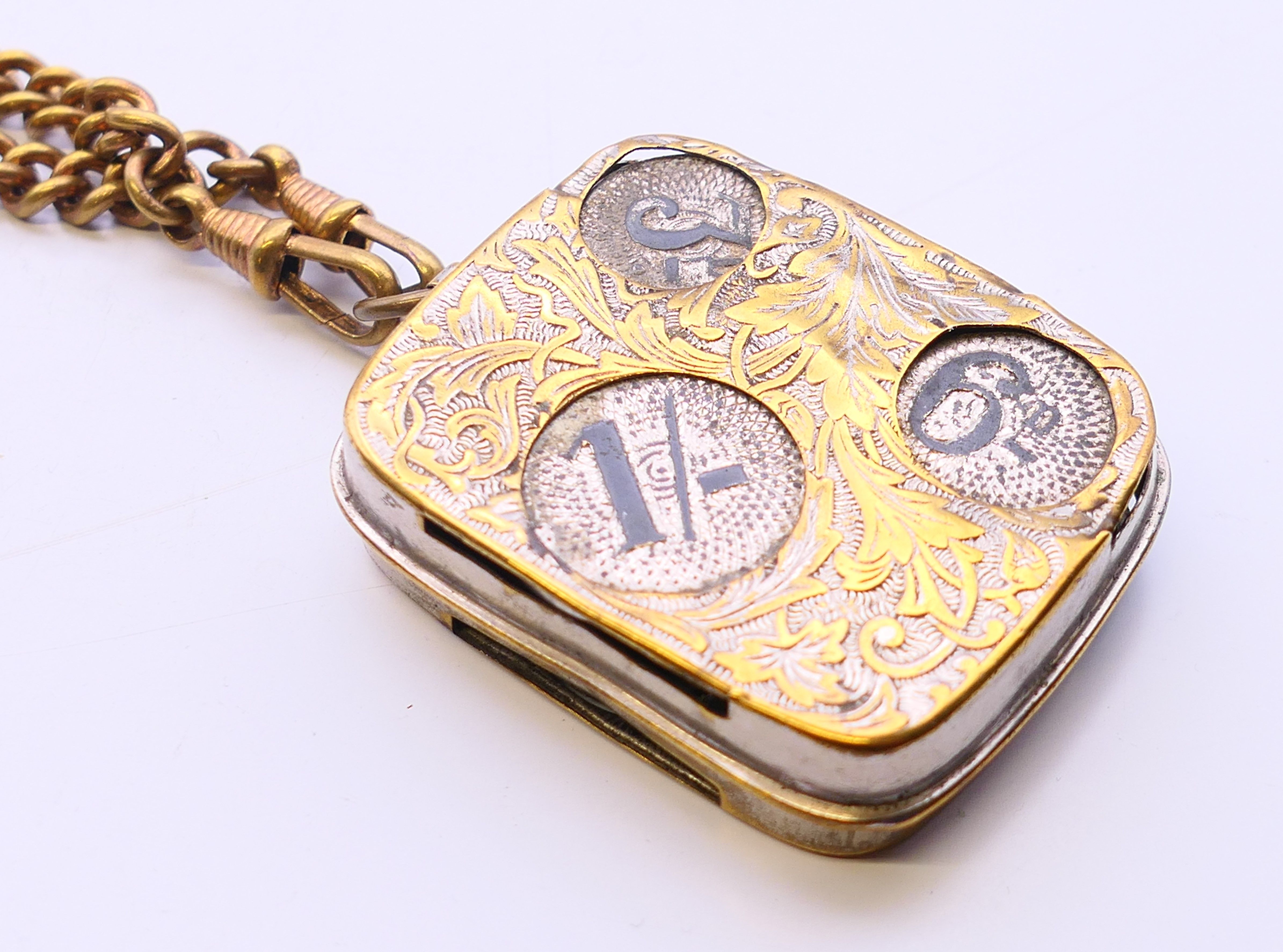 An Edwardian coin dispenser on chain. 5 cm x 4 cm. - Image 4 of 5