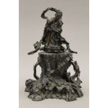 A 19th century Oriental bronze figure of Guanyin standing on a cast rockwork base with dragons.