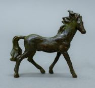 A bronze model of a horse. 8.5 cm long.