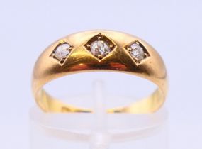 An 18 ct gold old cut diamond three stone gypsy ring, estimated total weight 0.