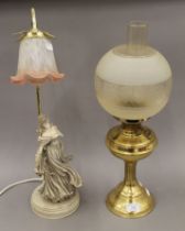 A brass oil lamp and a lamp formed as a lady. The former 54 cm high.