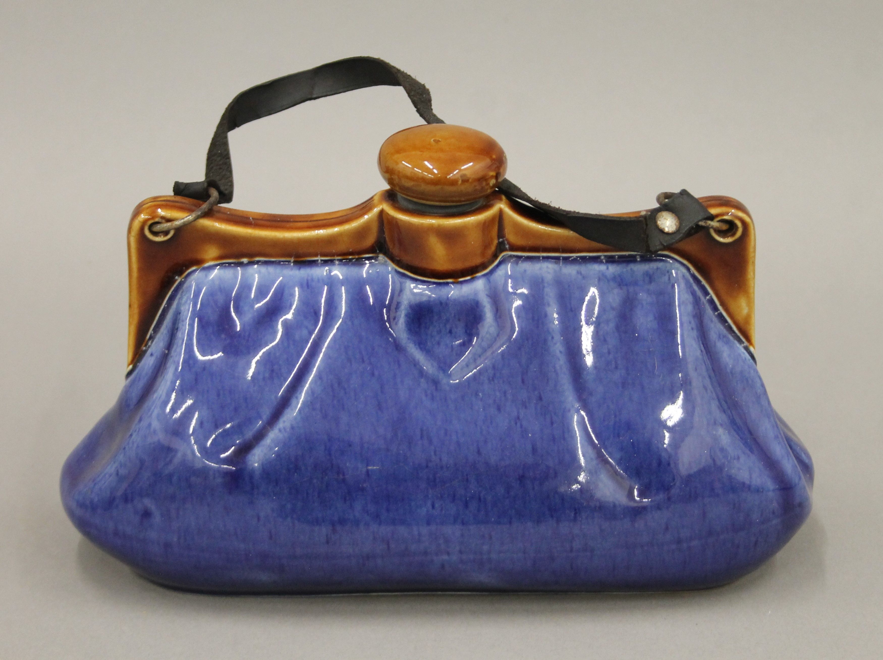 A Bourne Denby stoneware hot water bottle in the form of a ladies handbag. 25 cm long.