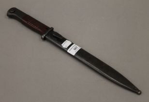 A bayonet in scabbard. 40 cm long.