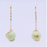 A pair of gold and jade ball earrings. 3.5 cm high.