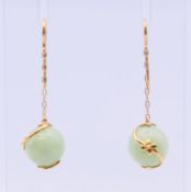A pair of gold and jade ball earrings. 3.5 cm high.