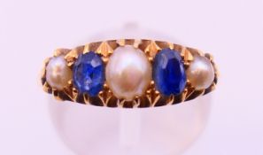 An 18 ct gold, seed pearl and sapphire ring. Ring size N.
