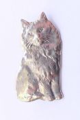 A silver brooch in the form of a cat. 3 cm high.