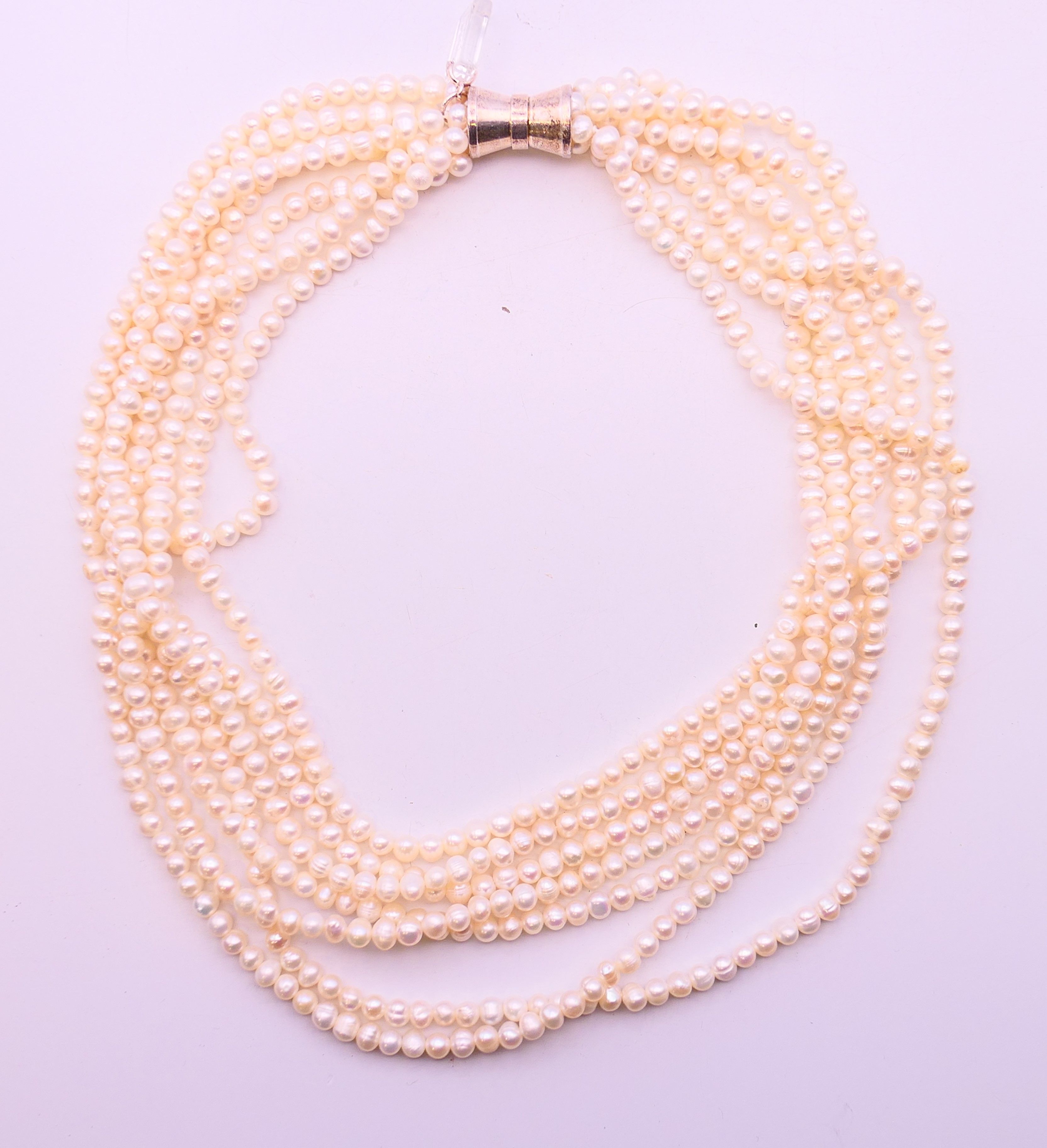 An Aska six-string pearl necklace. Approximately 46 cm long.