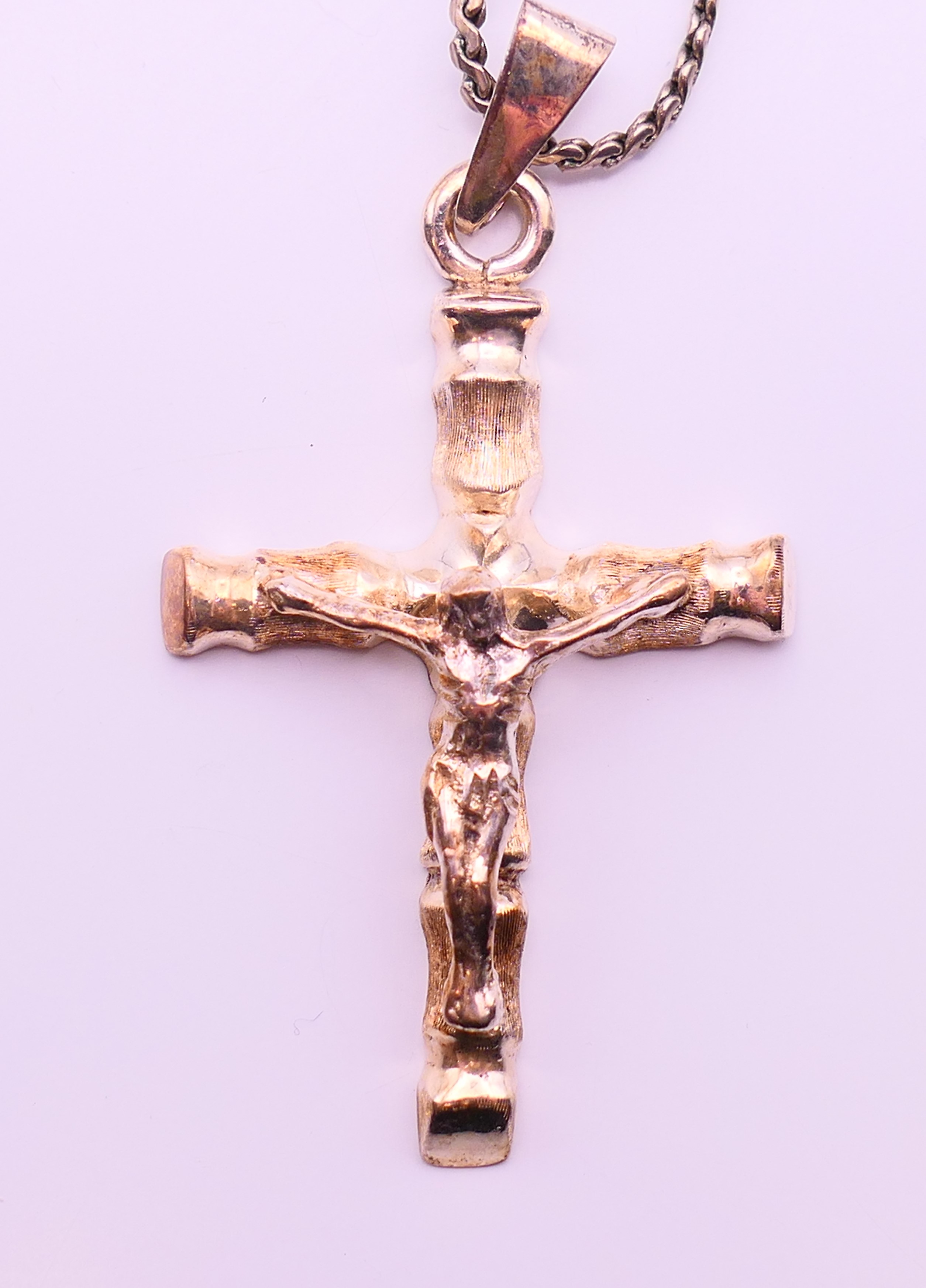 A silver crucifix on a silver chain. - Image 2 of 6