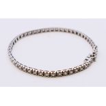 A white gold and diamond line bracelet. 18 cm long.