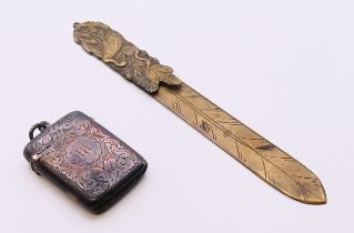 A silver vesta and a Japanese brass letter knife. Vesta 4.5 cm x 3.5 cm, knife 15.5 cm long.