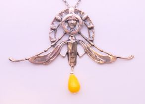 A silver Art Nouveau-style winged female head and bead pendant on a silver chain.