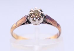 An 18 ct gold and platinum brilliant cut diamond single stone ring, illusion setting, estimated 0.