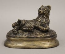 A bronze figure of a recumbent cat, signed Mene. 13.5 cm wide.
