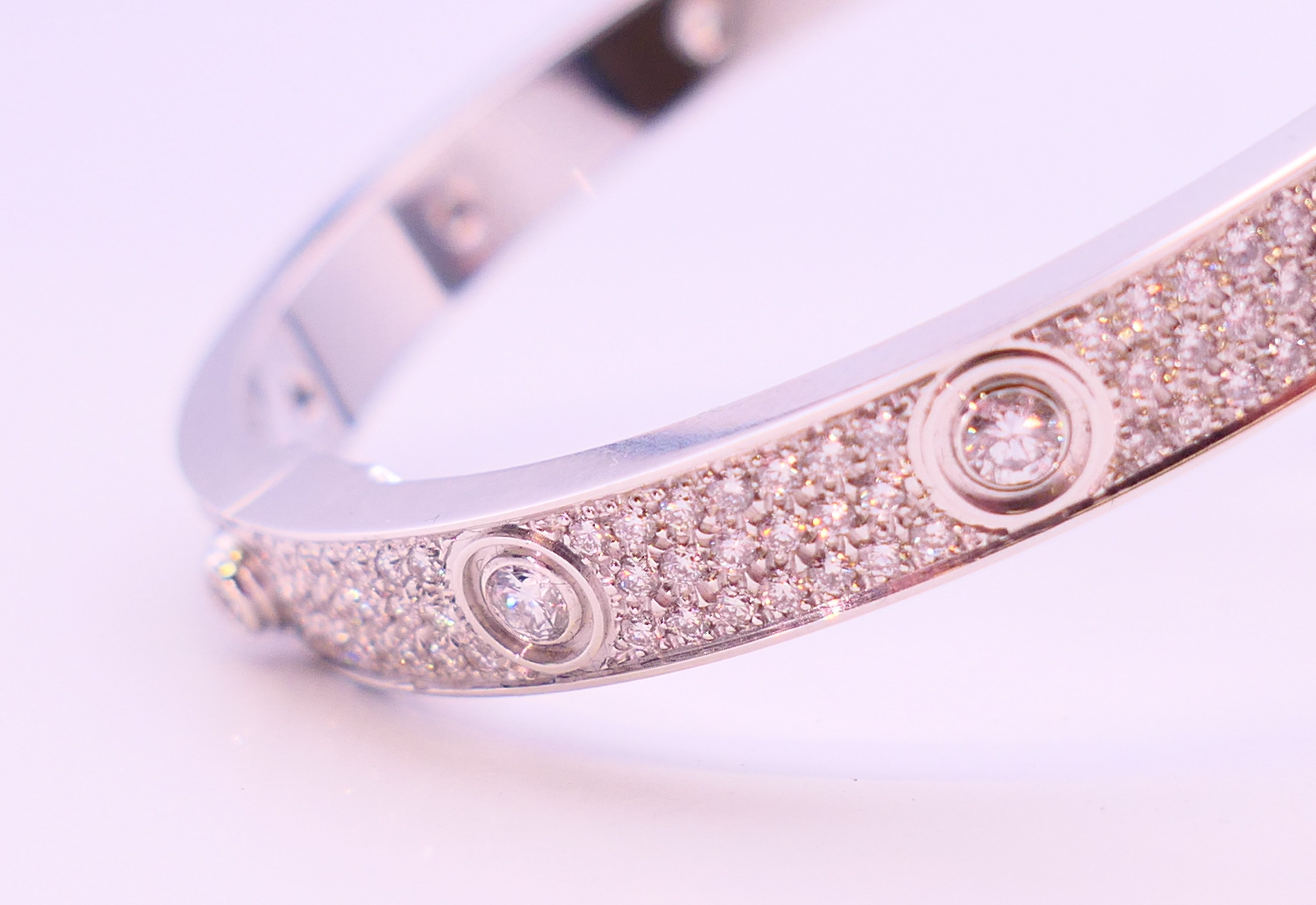 A Cartier 18 K white gold and diamond encrusted love bangle numbered 19 PDR729. 6. - Image 7 of 13