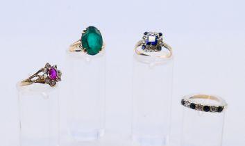 Four 9 ct gold rings, 8.89 grammes total weight.