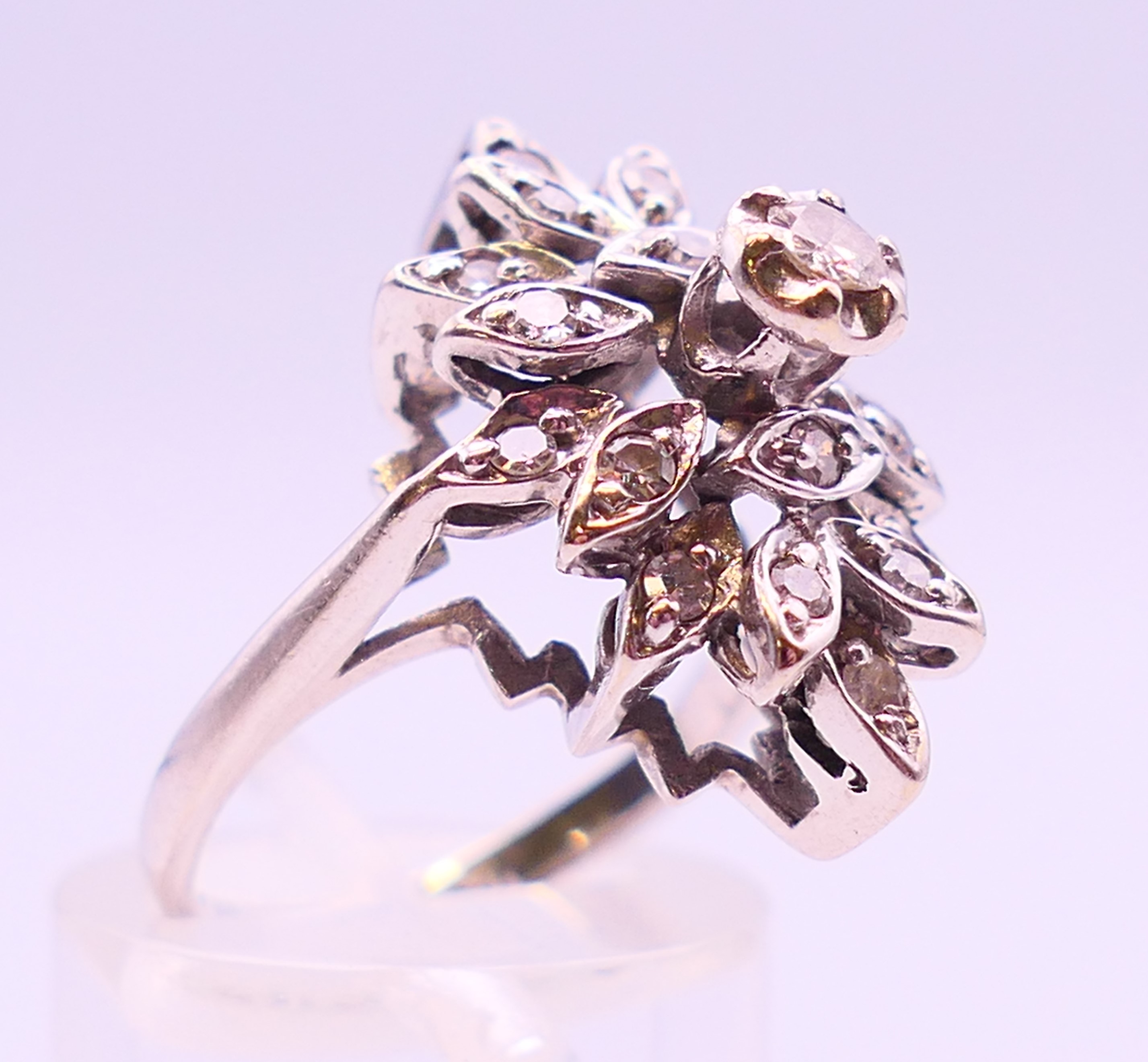 A platinum and diamond flowerhead ring. Ring size K/L. - Image 3 of 5