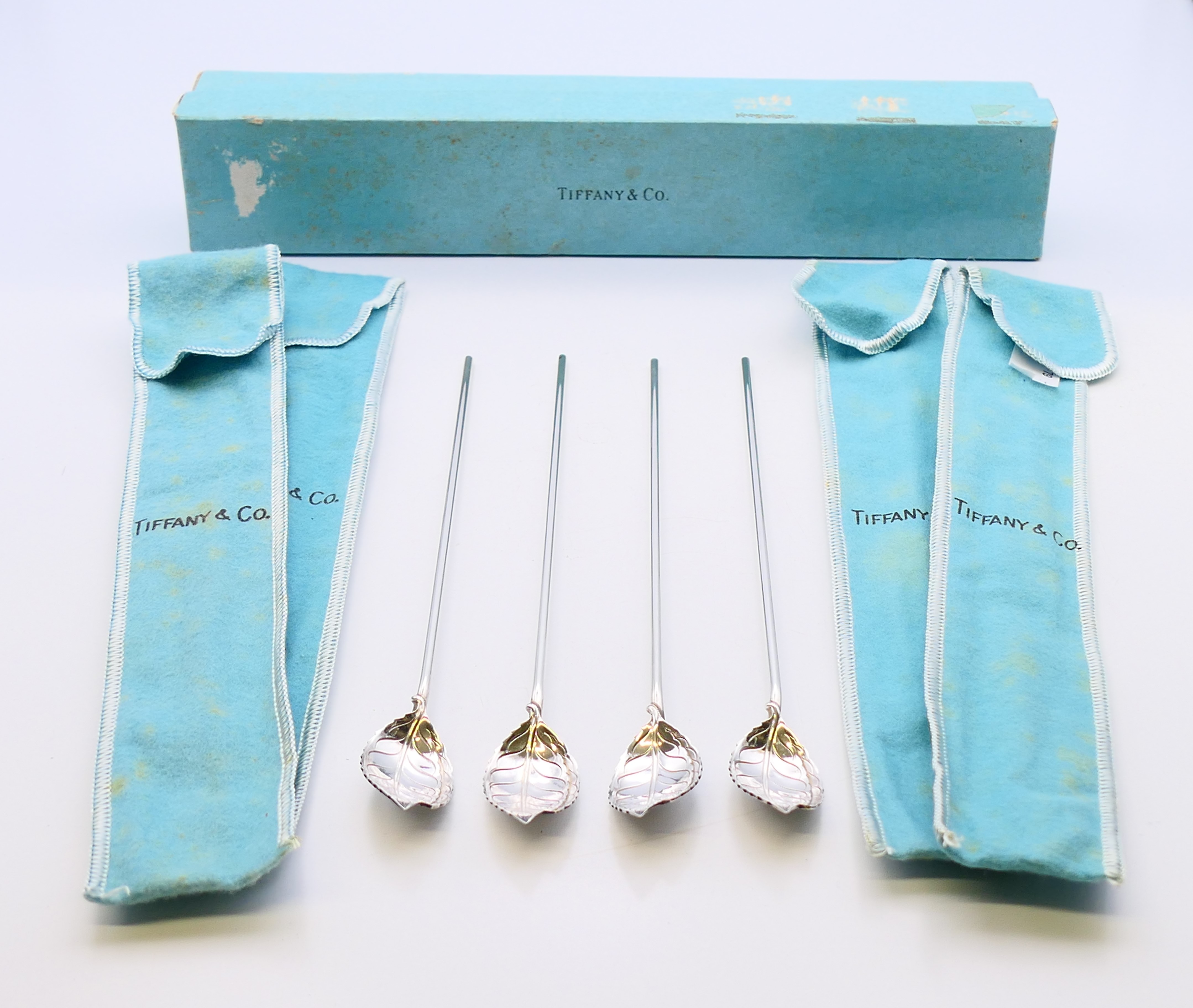 Four boxed Tiffany and Co silver cocoa spoons. 21.5 cm high.