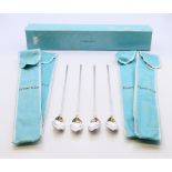 Four boxed Tiffany and Co silver cocoa spoons. 21.5 cm high.