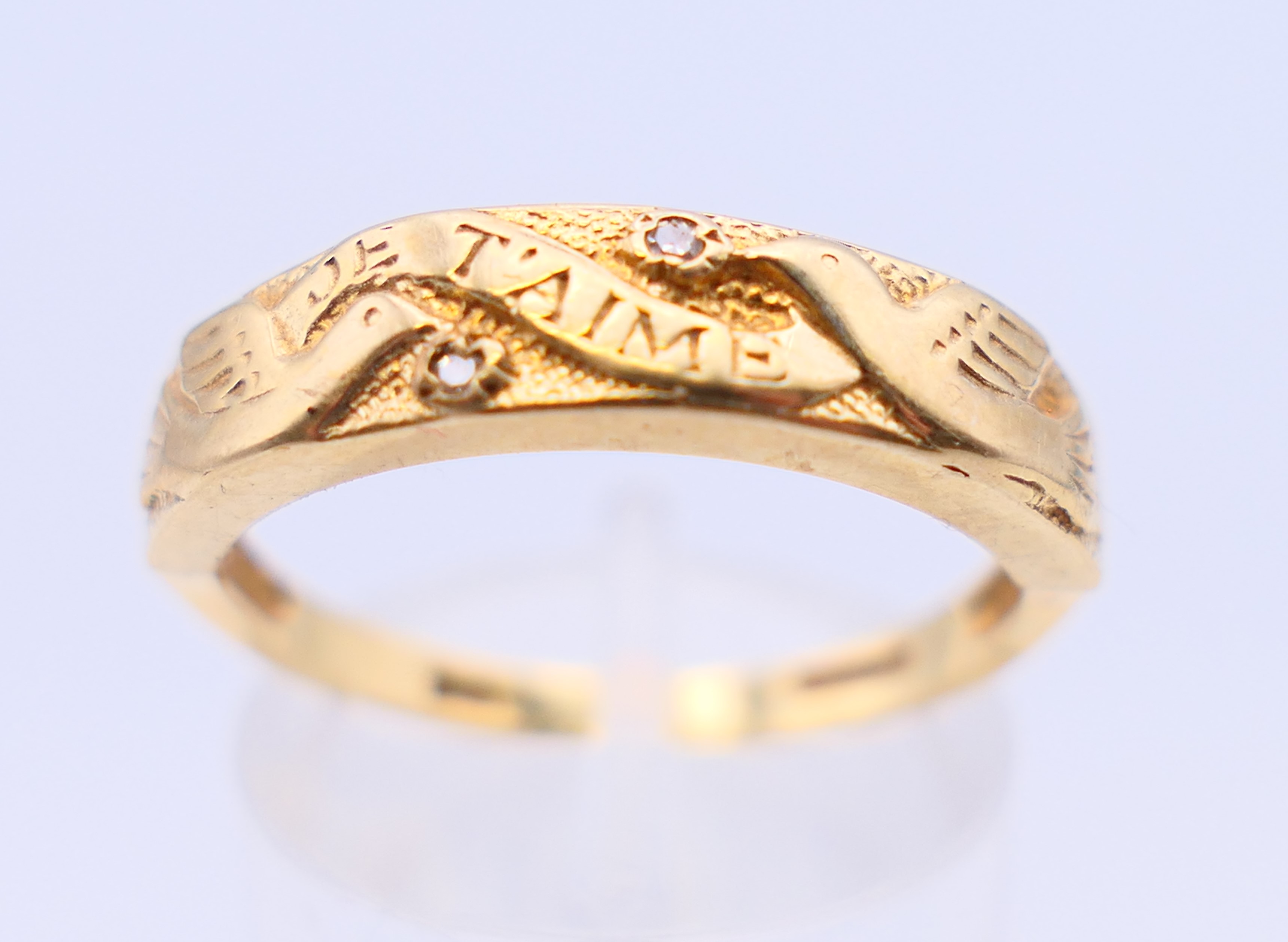 A 9 ct gold and diamond ring with two doves and marked Je T'aime. Ring size Q/R.