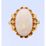 An unmarked 22 ct gold and opal ring. Ring size J.