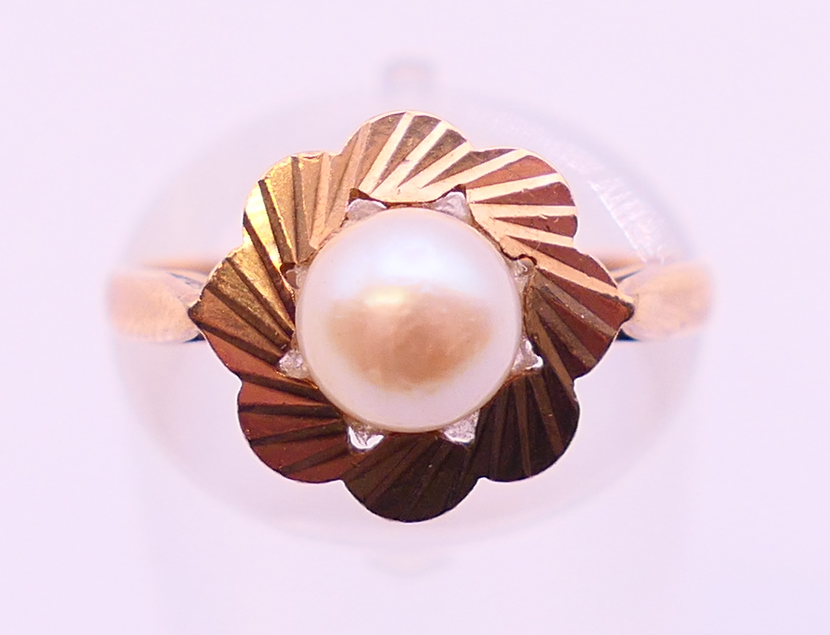 A 9 ct gold cultured pearl (6.2mm) single stone ring. Ring size M.