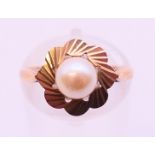 A 9 ct gold cultured pearl (6.2mm) single stone ring. Ring size M.