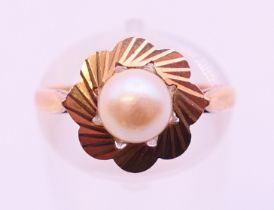 A 9 ct gold cultured pearl (6.2mm) single stone ring. Ring size M.