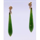 A pair of 9 ct gold and jade earrings. 4 cm high.
