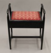 An Edwardian ebonised piano stool. 50 cm wide.