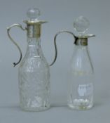 Two silver top cut glass oil and vinegar bottles, both with English silver marks. The tallest 14.