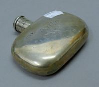 A silver hip flask. 10 cm wide. 125.8 grammes.