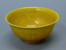 A Chinese yellow porcelain vase. 15.5 cm diameter.