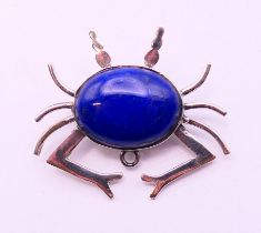 A silver and lapiz brooch in the form of a crab. 3 cm high.