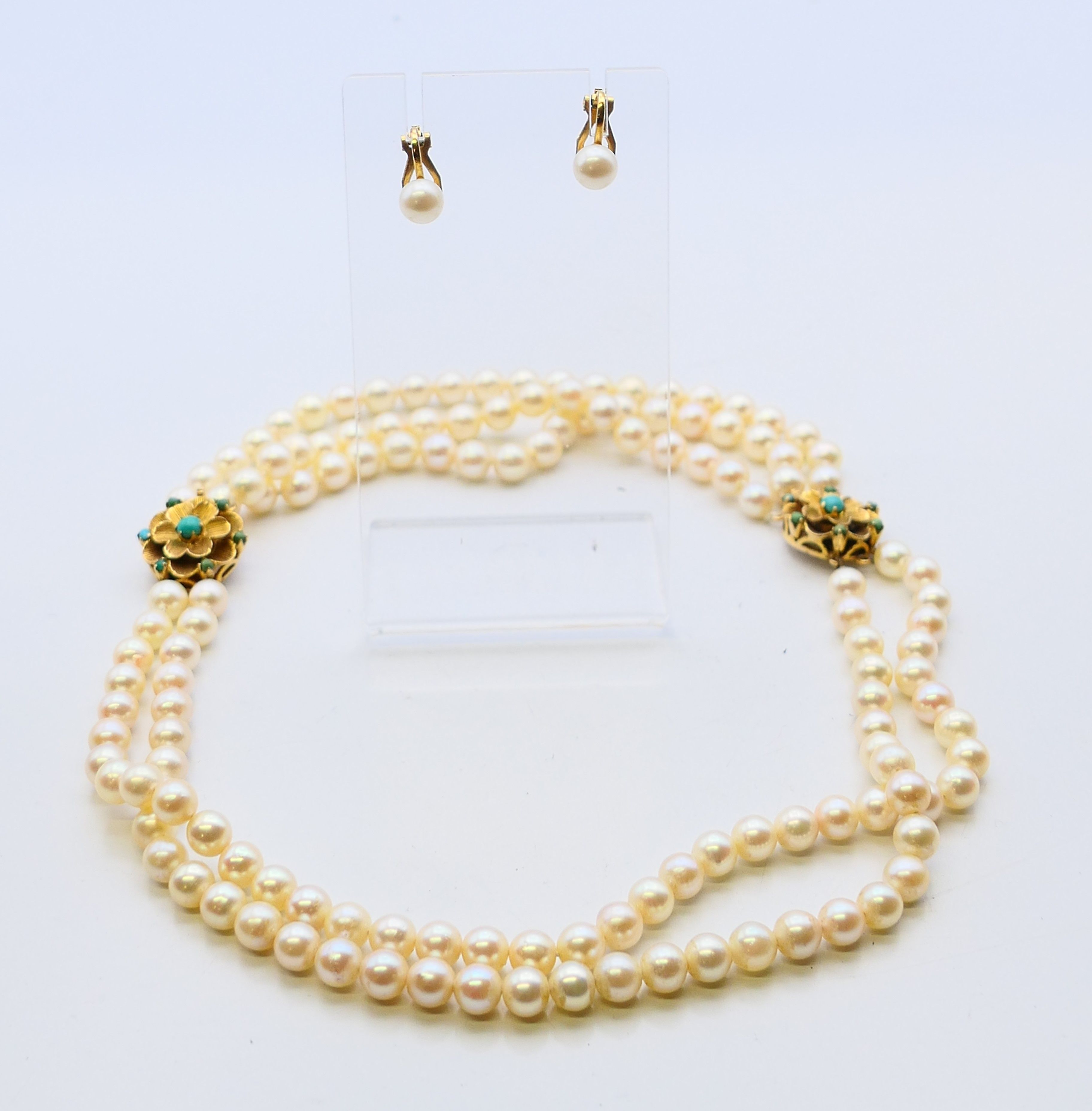 A 9 ct gold clasp pearl necklace and a pair of gold pearl earrings. Necklace 44 cm long.