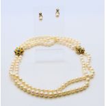 A 9 ct gold clasp pearl necklace and a pair of gold pearl earrings. Necklace 44 cm long.