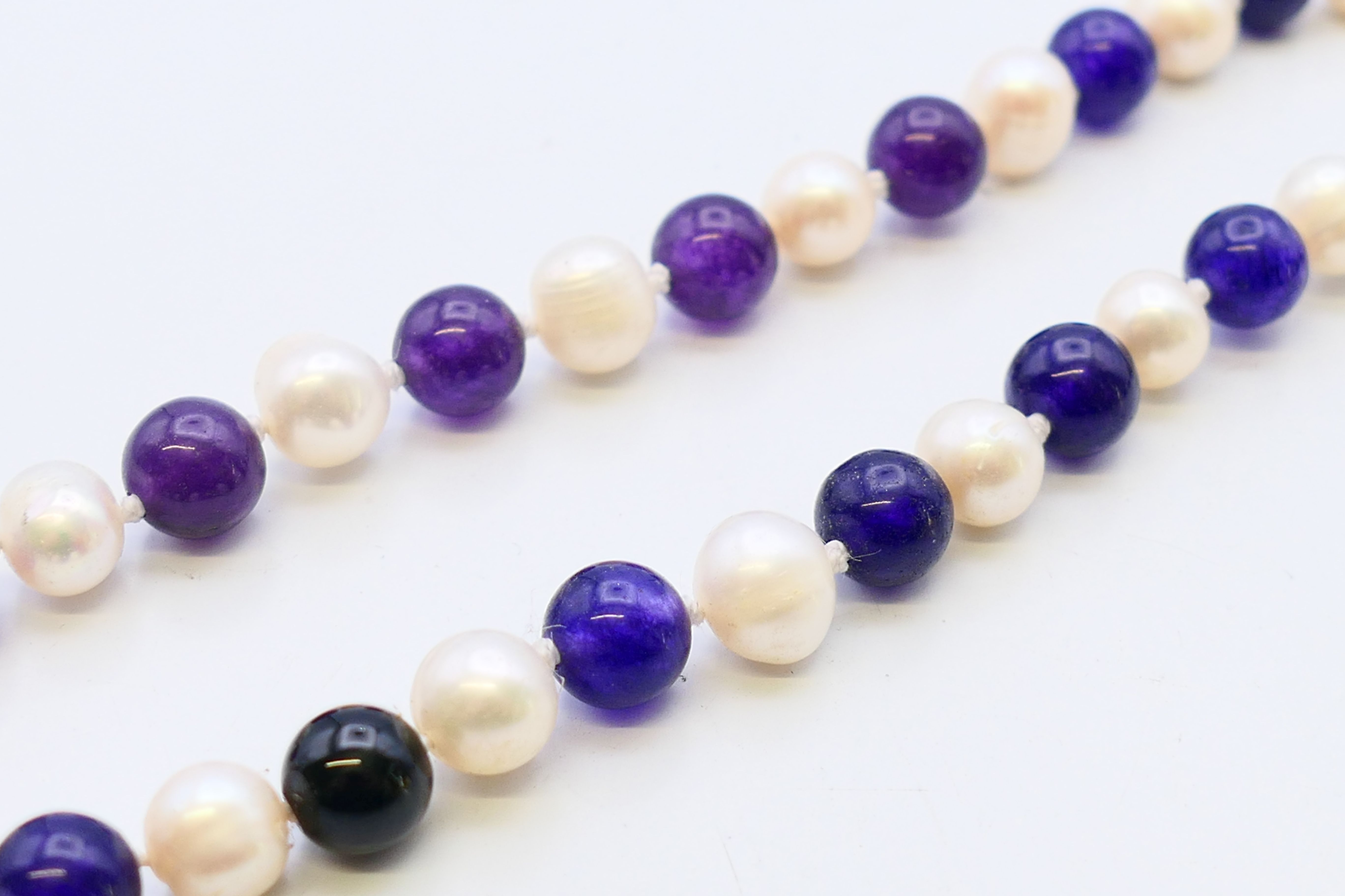 A string of amethyst and pearl beads. 122 cm high. - Image 2 of 2