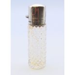 A silver top cut glass scent bottle, hallmarked for Birmingham. 8 cm high.