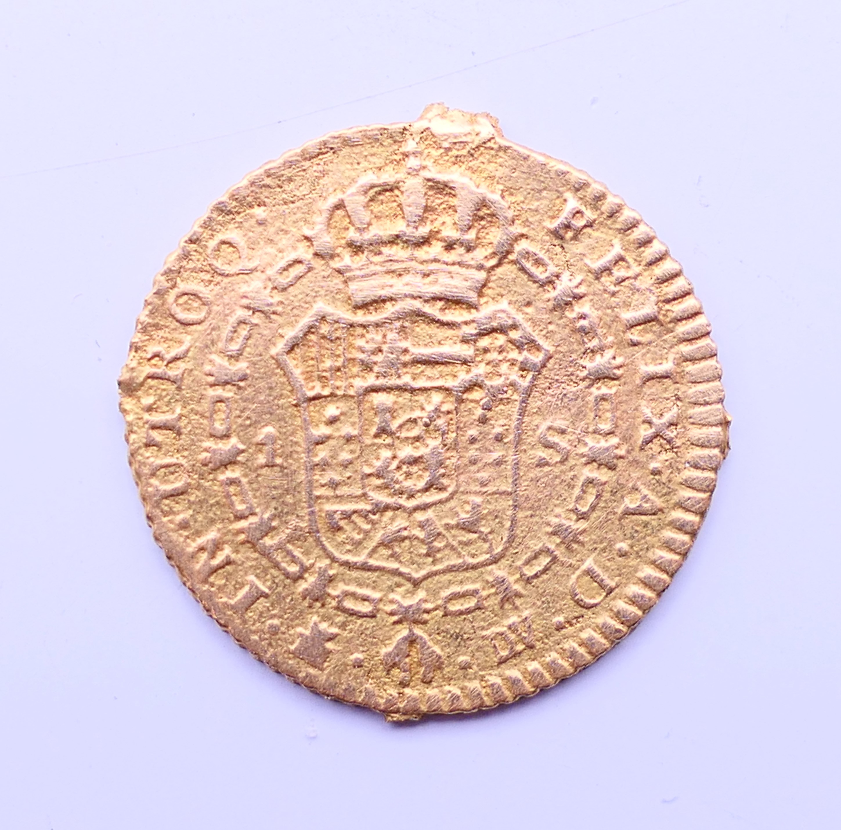 A 1787 gold Escudo coin. 1.75 cm diameter. 2.1 grammes. - Image 2 of 4