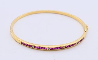 An 18 ct gold, ruby and diamond hinged bangle with twenty-five square shaped rubies (2mm),