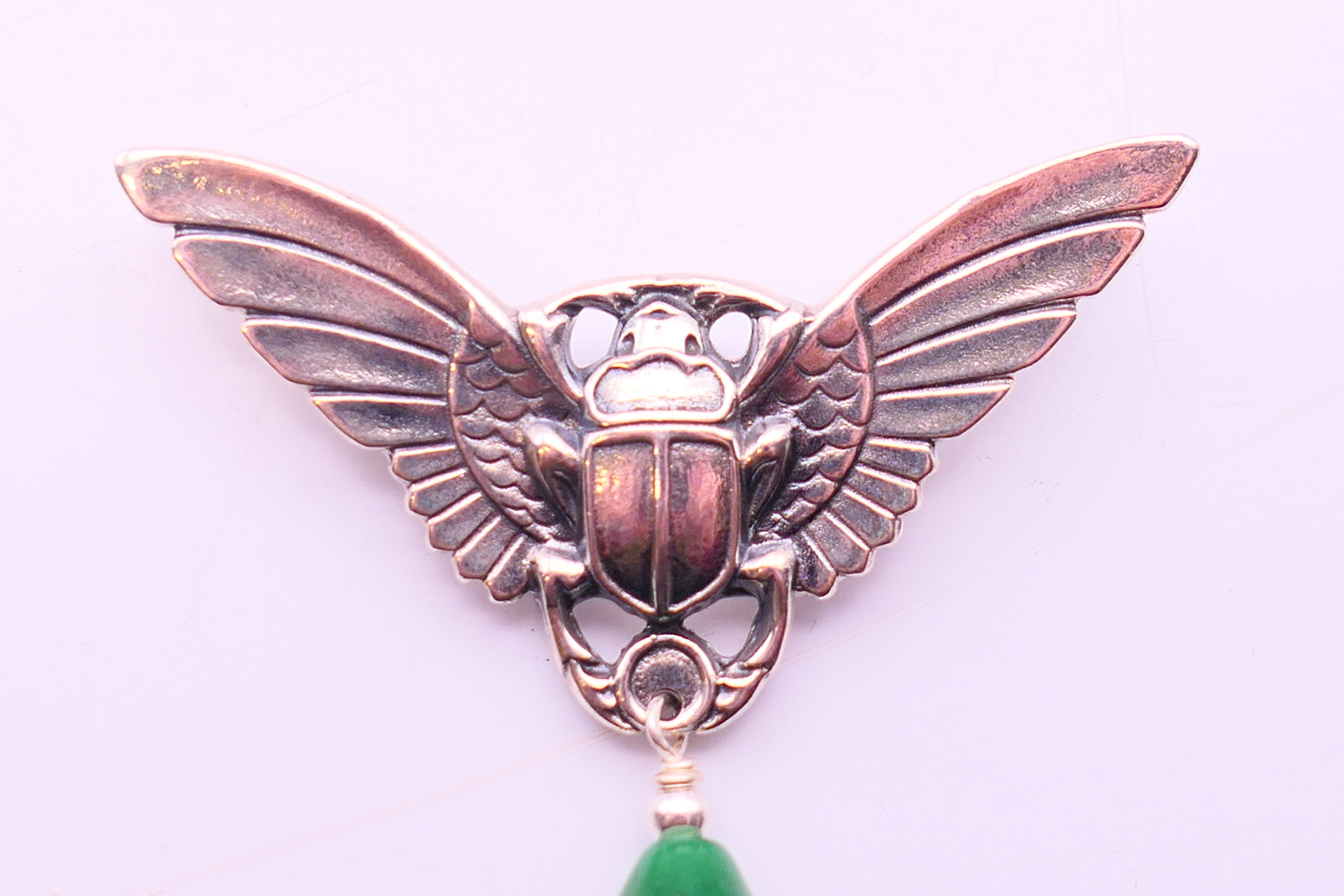 A silver and jade brooch in the form of a winged scarab beetle. 5 cm high x 5.5 cm wide. - Image 2 of 5