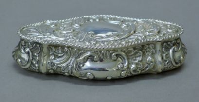 An embossed silver box. 16.5 cm long. 114.9 grammes.